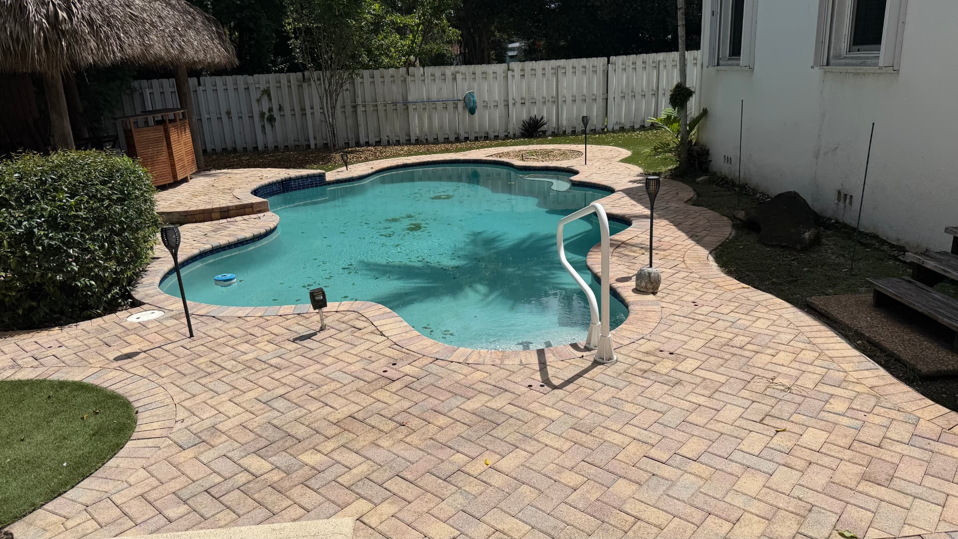 The same brick paver pool deck restored to a bright, clean finish after cleaning
